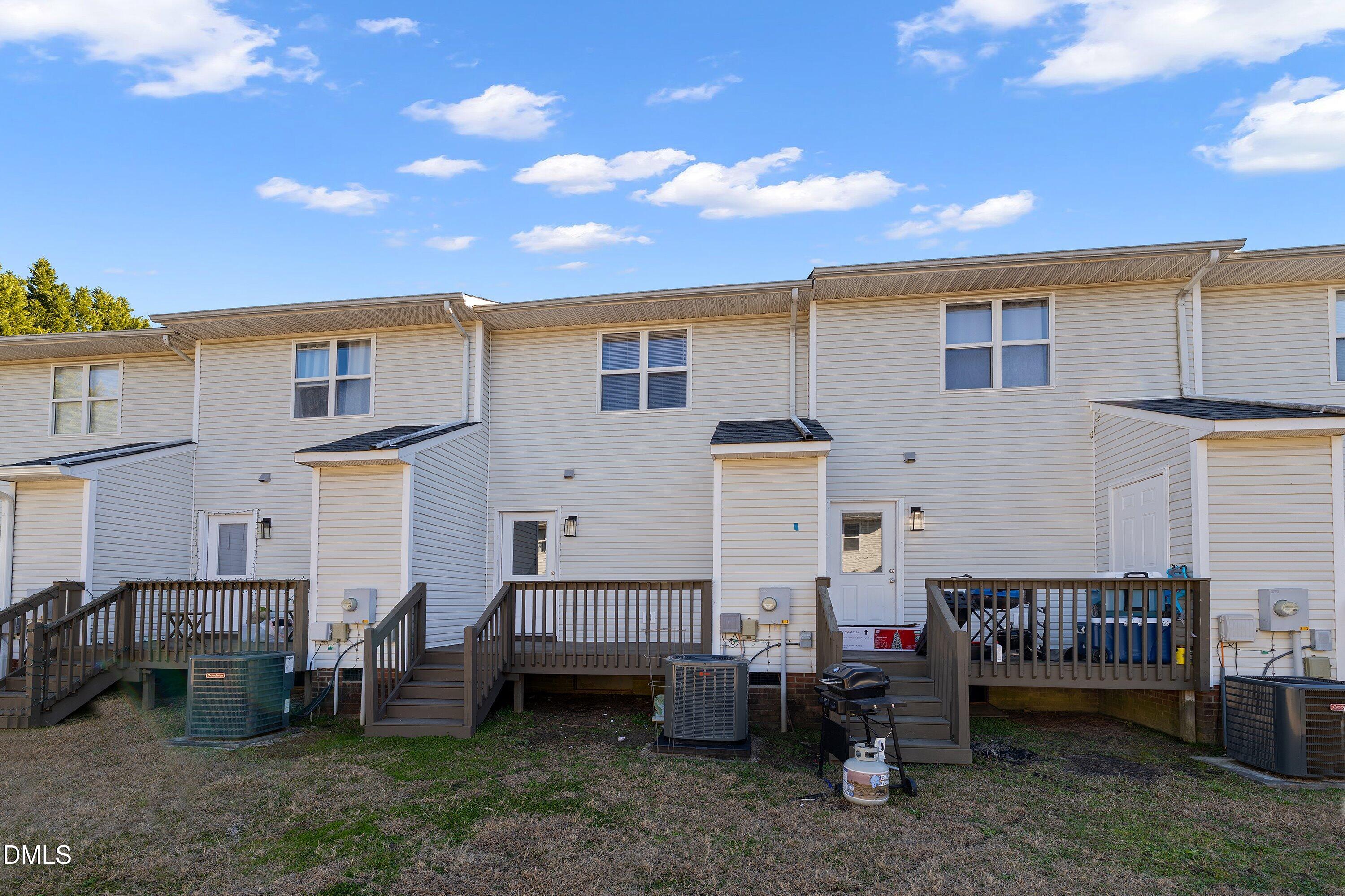 389 East Williams Street Angier, NC 27501 - Photo 25 of 26 a view of a house with a wooden deck and furniture