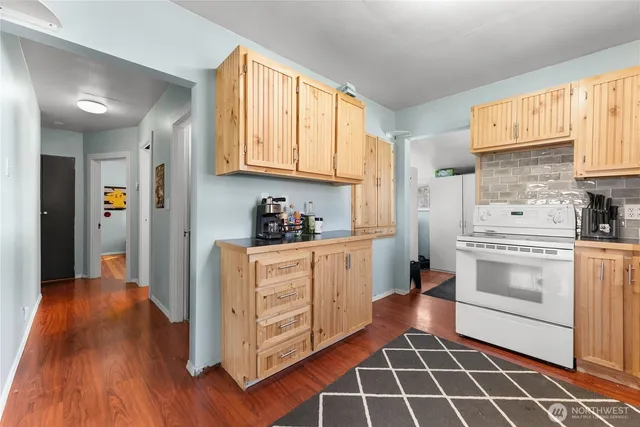 a kitchen with stainless steel appliances a stove a sink and a refrigerator