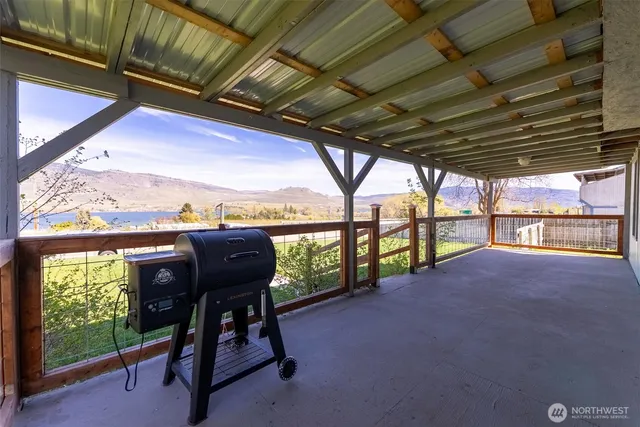 a view of a porch with furniture and a floor to ceiling window
