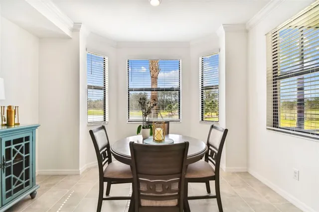 a view of a dining room with furniture and a window
