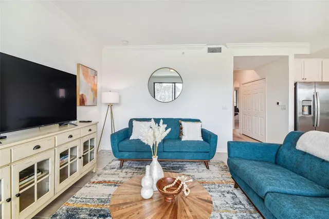 a living room with furniture and kitchen view