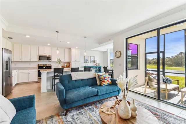 a living room filled with furniture and a large window