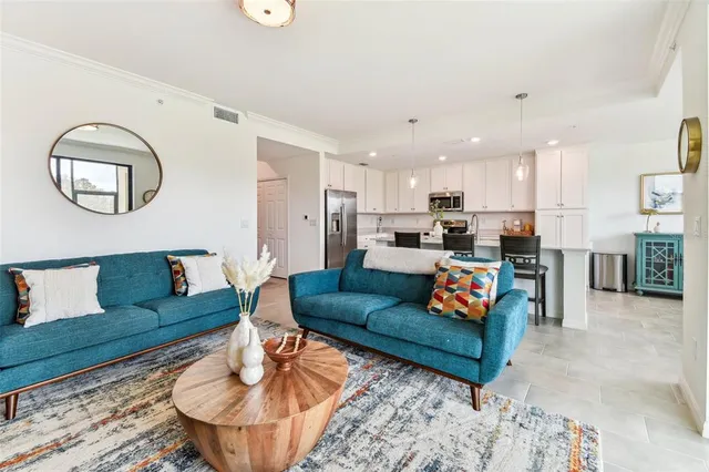 a living room with furniture and kitchen view