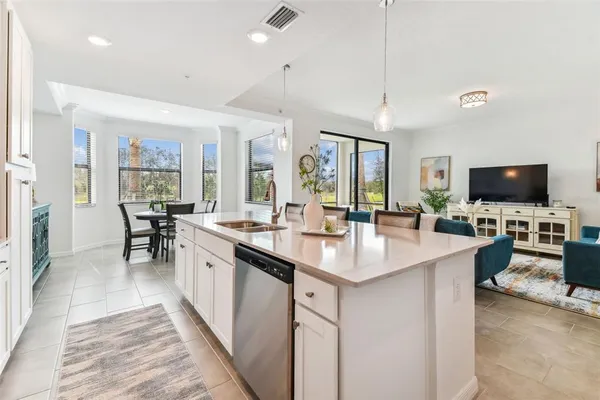 a living room with furniture and kitchen view