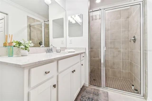 a bathroom with a double vanity sink mirror and shower