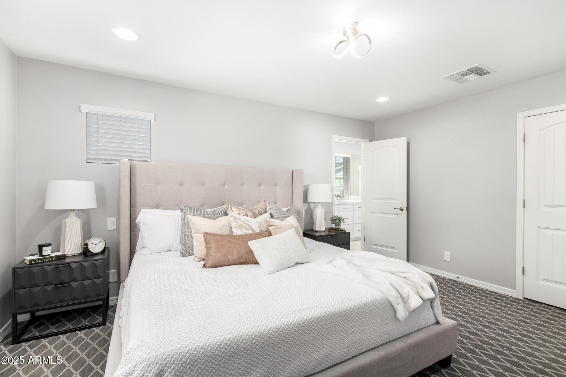 735 East Calavar Road Phoenix, AZ 85022 - Photo 11 of 38 a bedroom with a bed and a lamp