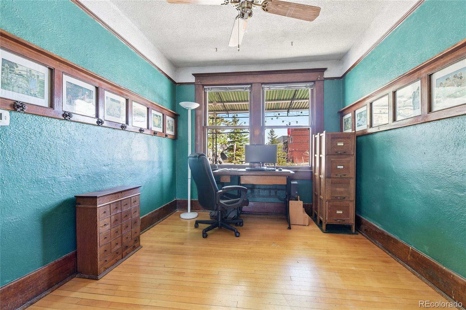 9490 Spruce Mountain Road Larkspur, CO 80118 - Photo 14 of 49 a view of a workspace with furniture and a window