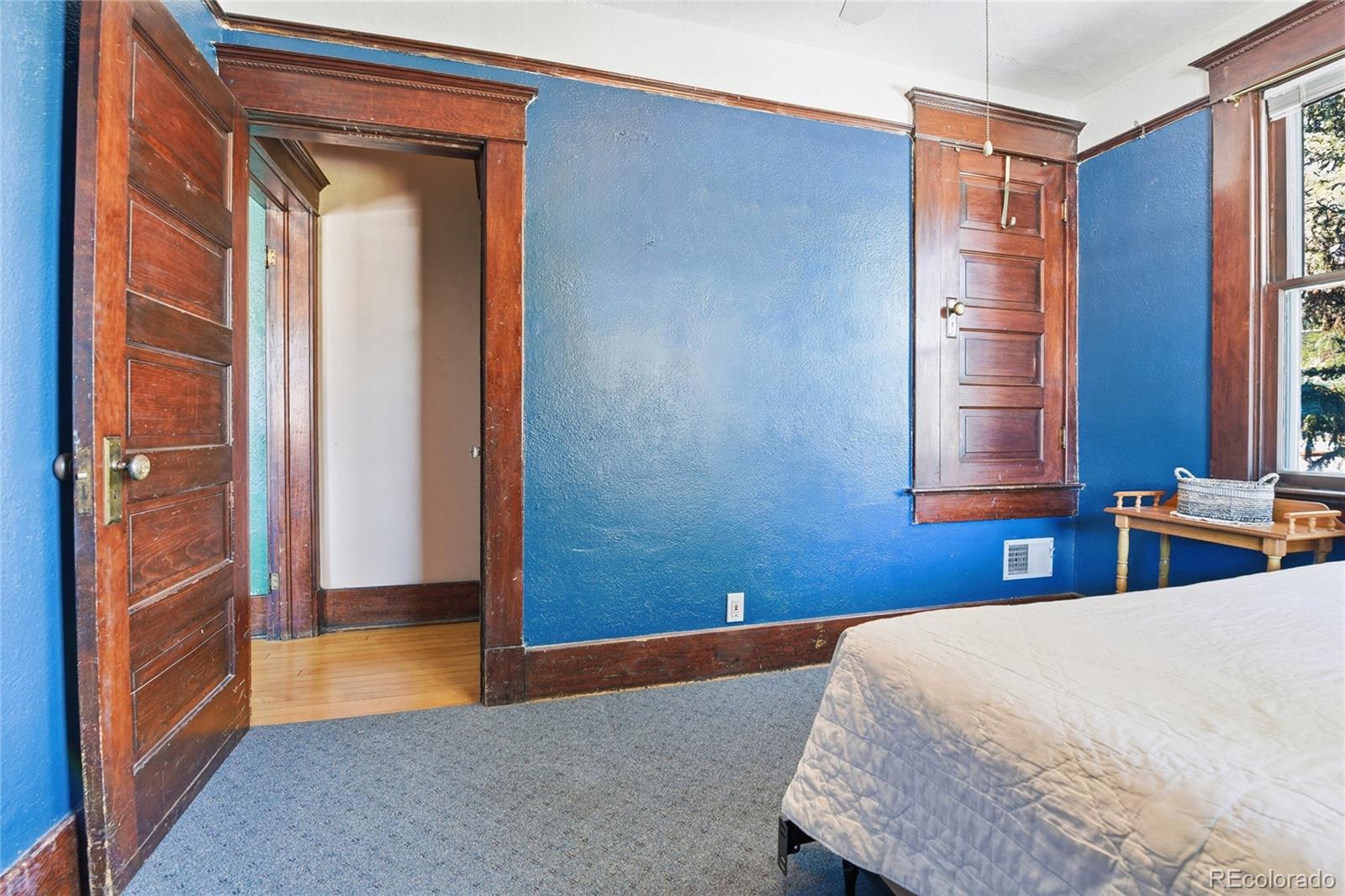 9490 Spruce Mountain Road Larkspur, CO 80118 - Photo 22 of 49 a bedroom with a bed and a window