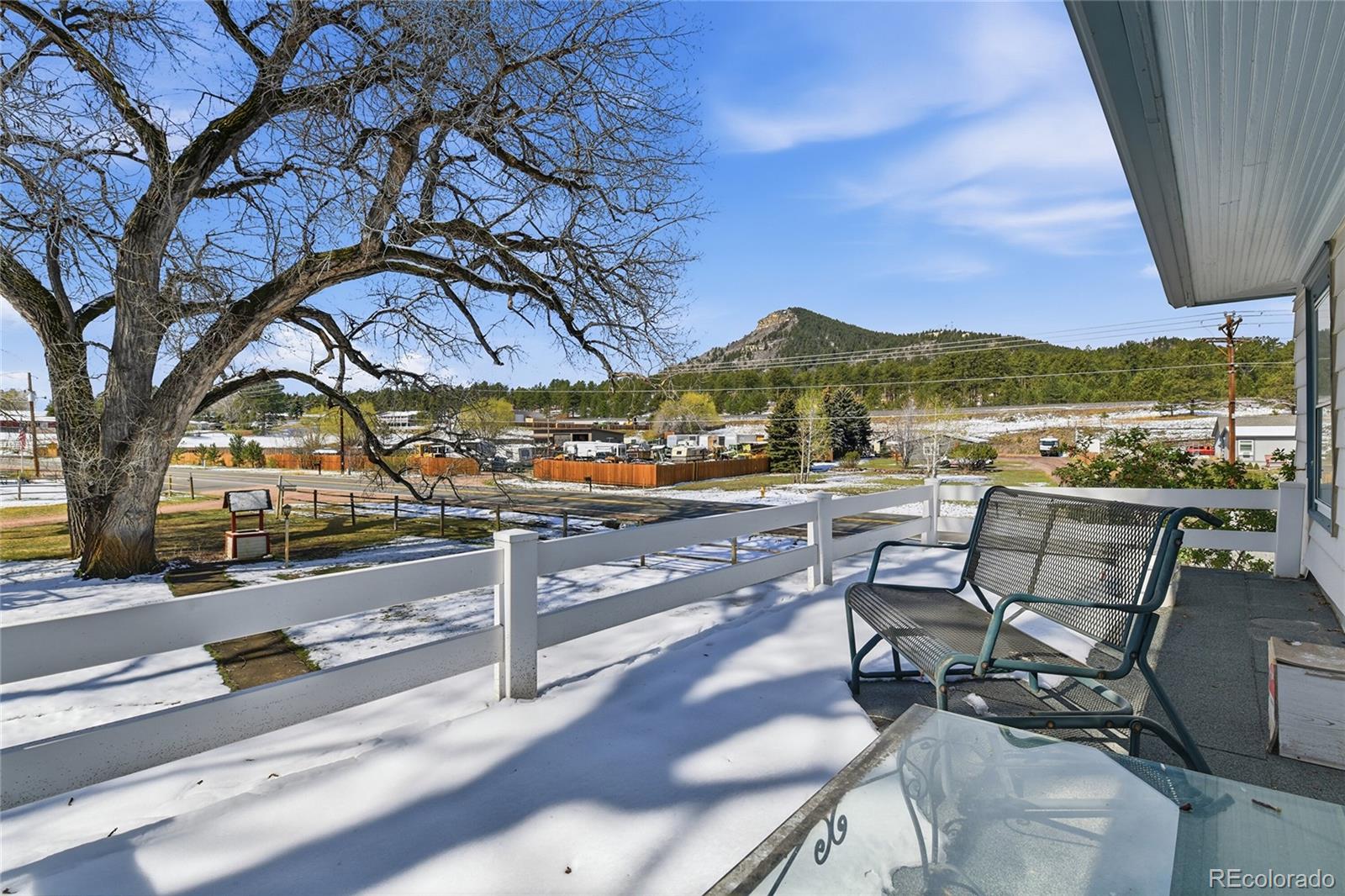 9490 Spruce Mountain Road Larkspur, CO 80118 - Photo 28 of 49 a view of a patio with a table and chairs