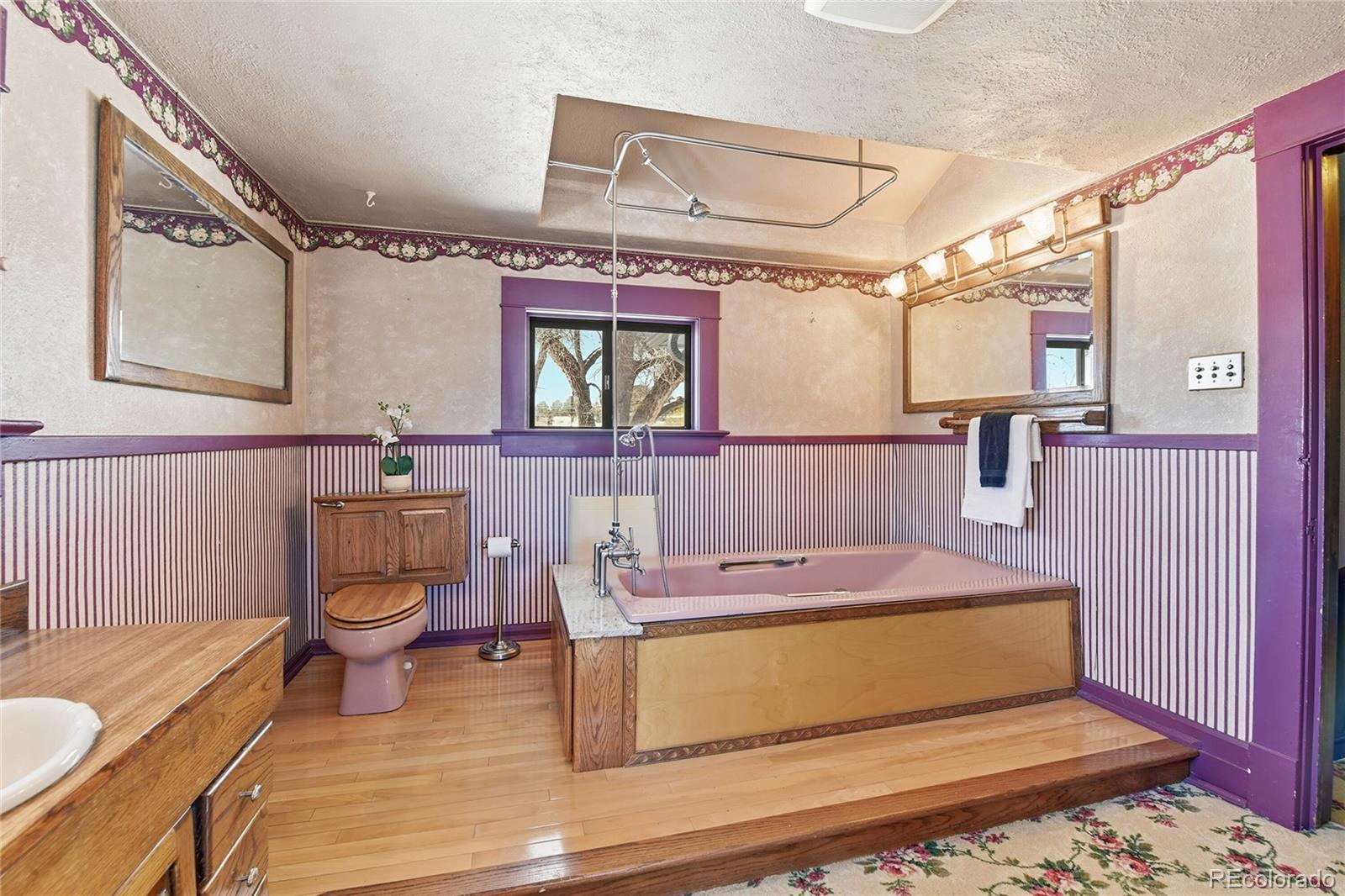 9490 Spruce Mountain Road Larkspur, CO 80118 - Photo 30 of 49 a bathroom with a granite countertop sink and a mirror
