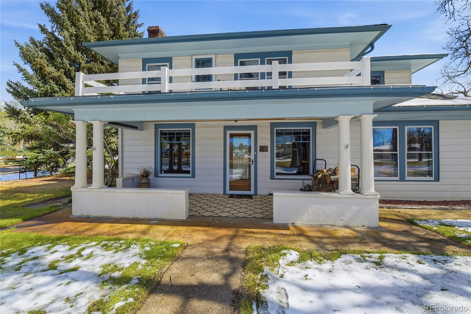 9490 Spruce Mountain Road Larkspur, CO 80118 - Photo 3 of 49 a front view of a house with a yard