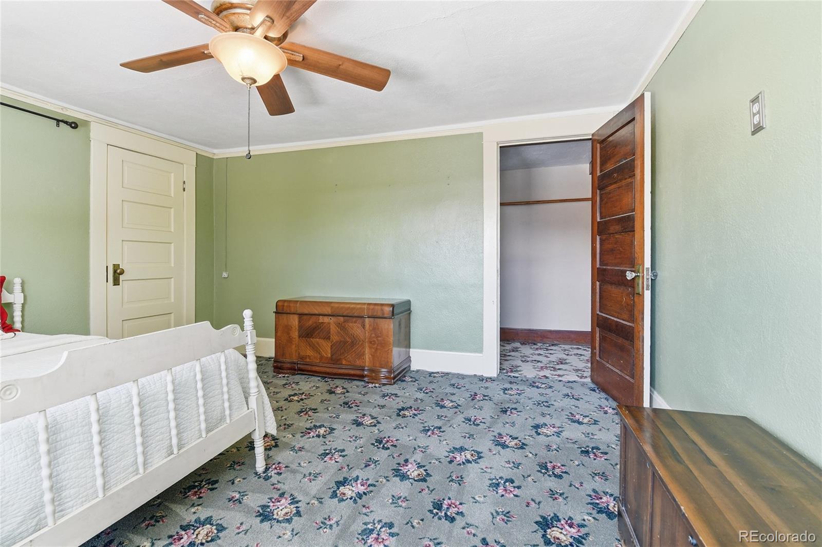 9490 Spruce Mountain Road Larkspur, CO 80118 - Photo 33 of 49 a bedroom with a bed and a walk in closet