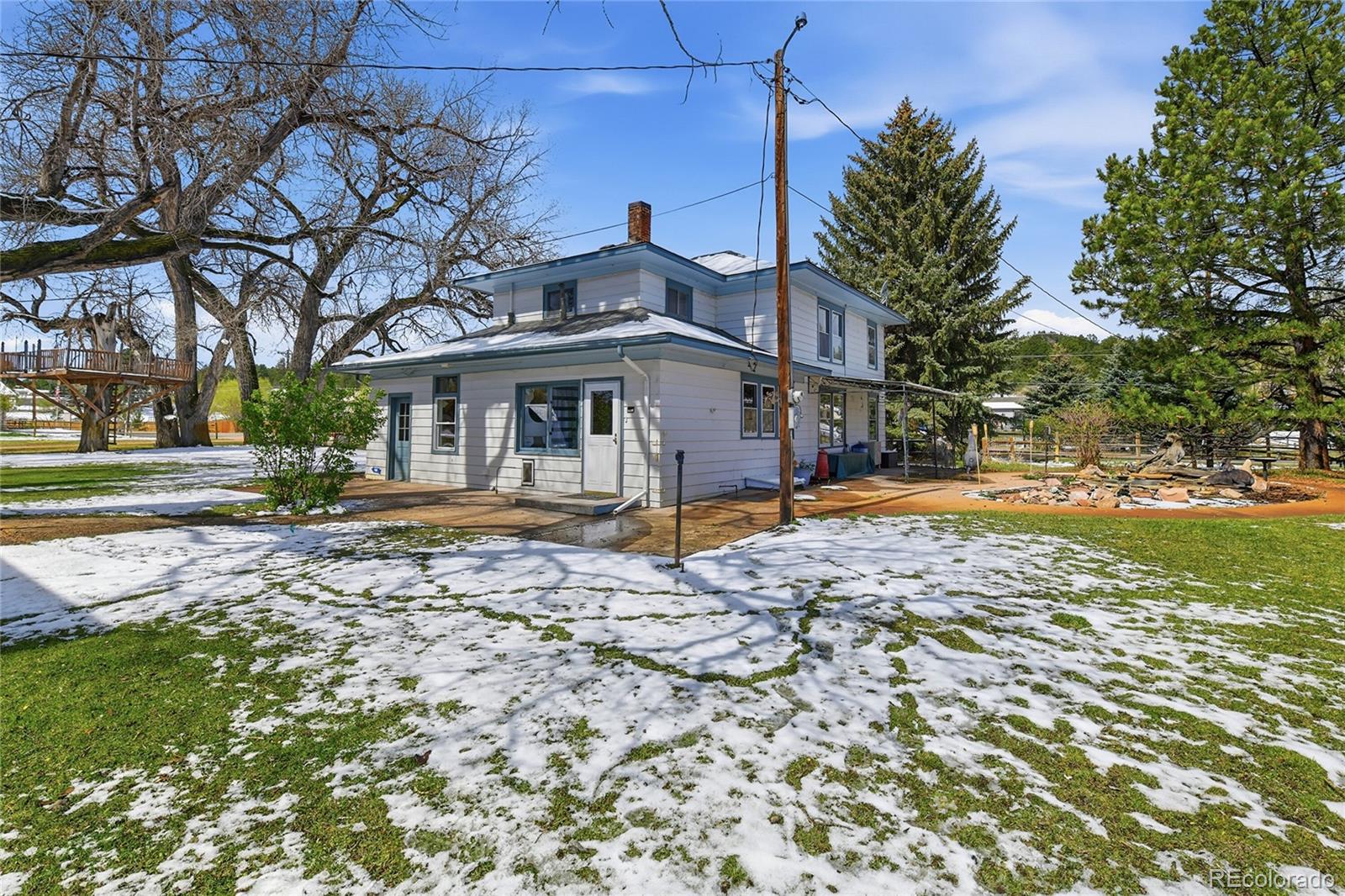 9490 Spruce Mountain Road Larkspur, CO 80118 - Photo 37 of 49 a view of a house with a yard