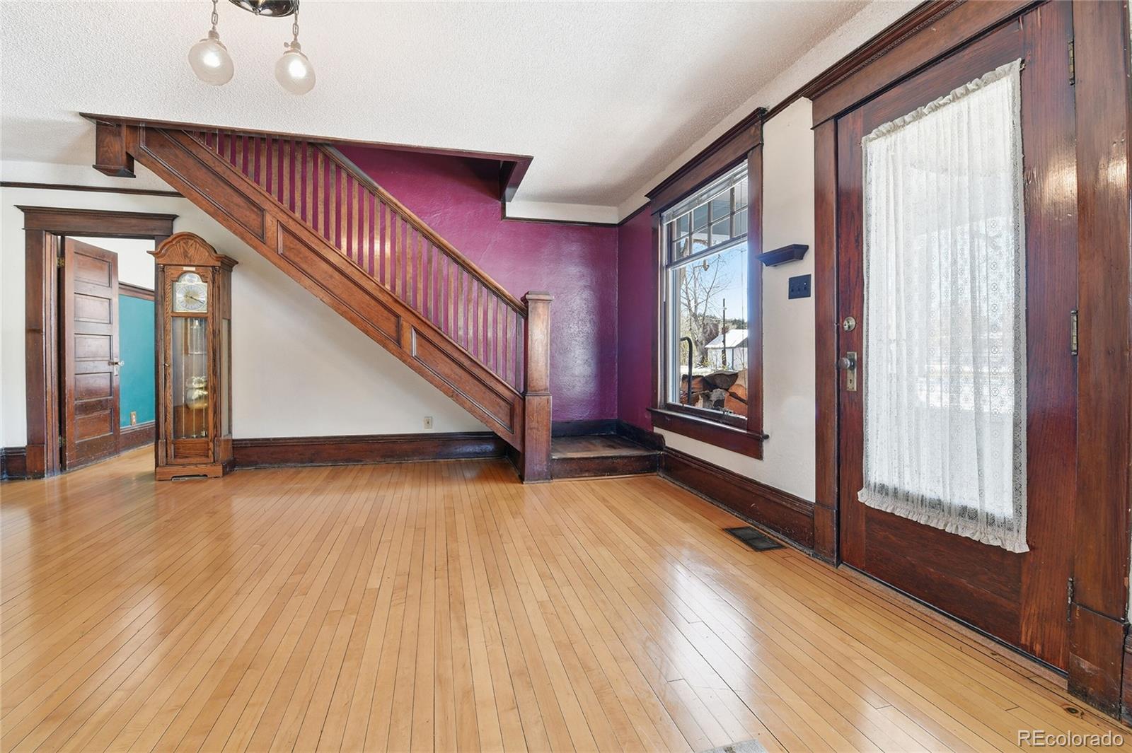 9490 Spruce Mountain Road Larkspur, CO 80118 - Photo 4 of 49 a view of an entryway with wooden floor