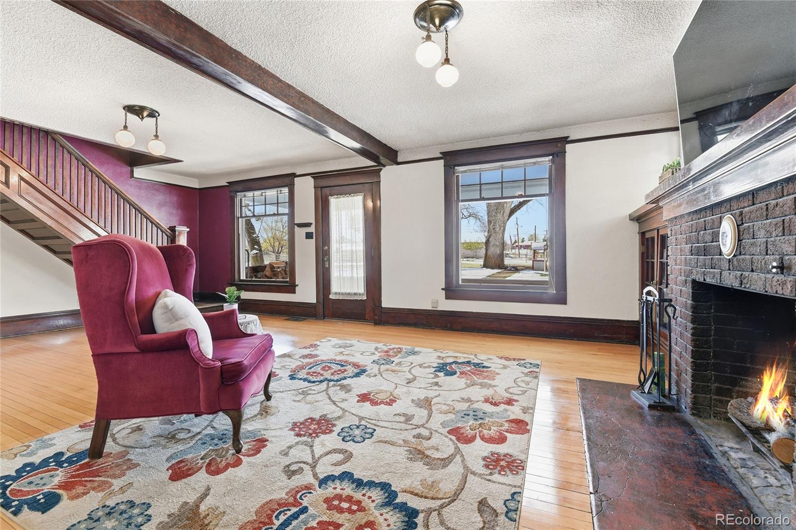 9490 Spruce Mountain Road Larkspur, CO 80118 - Photo 6 of 49 a bedroom with furniture and a fireplace
