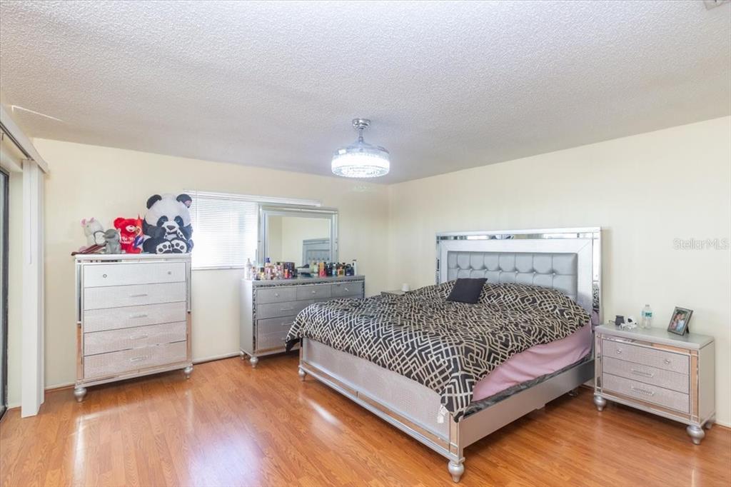 7264 Lindhurst Street Spring Hill, FL 34606 - Photo 12 of 24 a bedroom with a bed and wooden floor