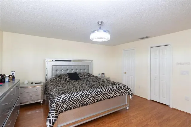a bedroom with a bed and a chandelier