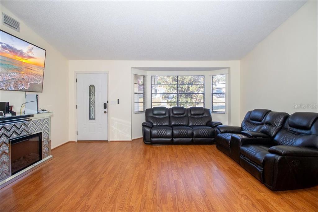 7264 Lindhurst Street Spring Hill, FL 34606 - Photo 19 of 24 a living room with furniture and a fireplace