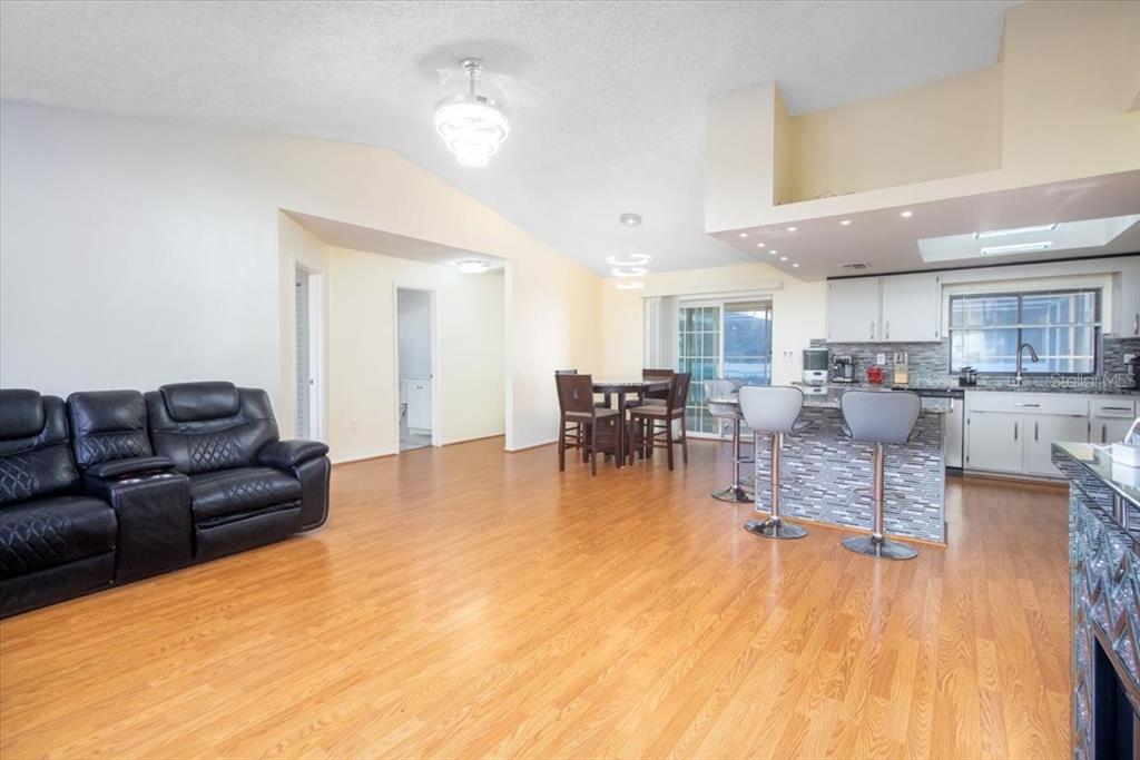 7264 Lindhurst Street Spring Hill, FL 34606 - Photo 20 of 24 a living room with furniture and kitchen view