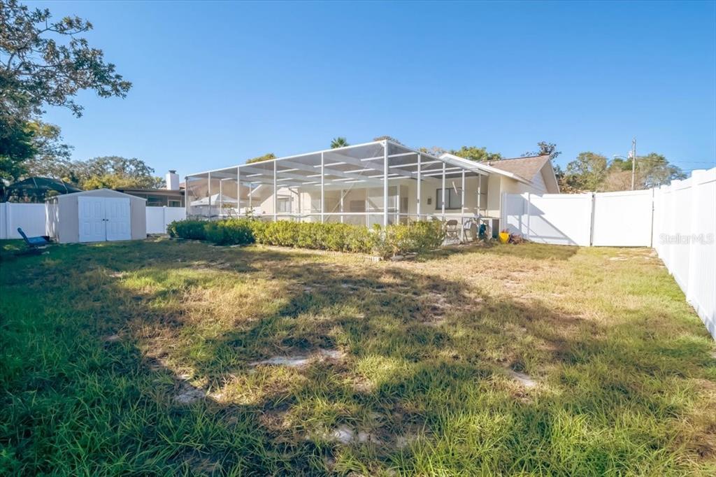 7264 Lindhurst Street Spring Hill, FL 34606 - Photo 7 of 24 a view of a big yard with a building in the background