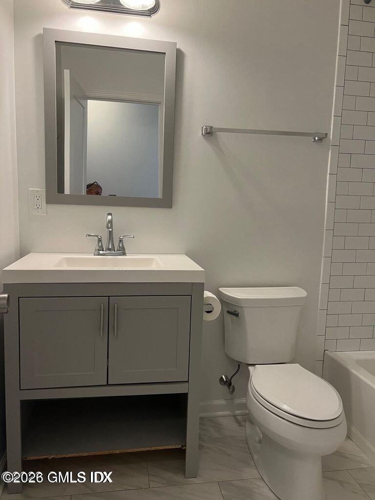 19 Bible Street, Unit 2 Cos Cob, CT 06807 - Photo 13 of 26 a bathroom with a toilet sink and mirror