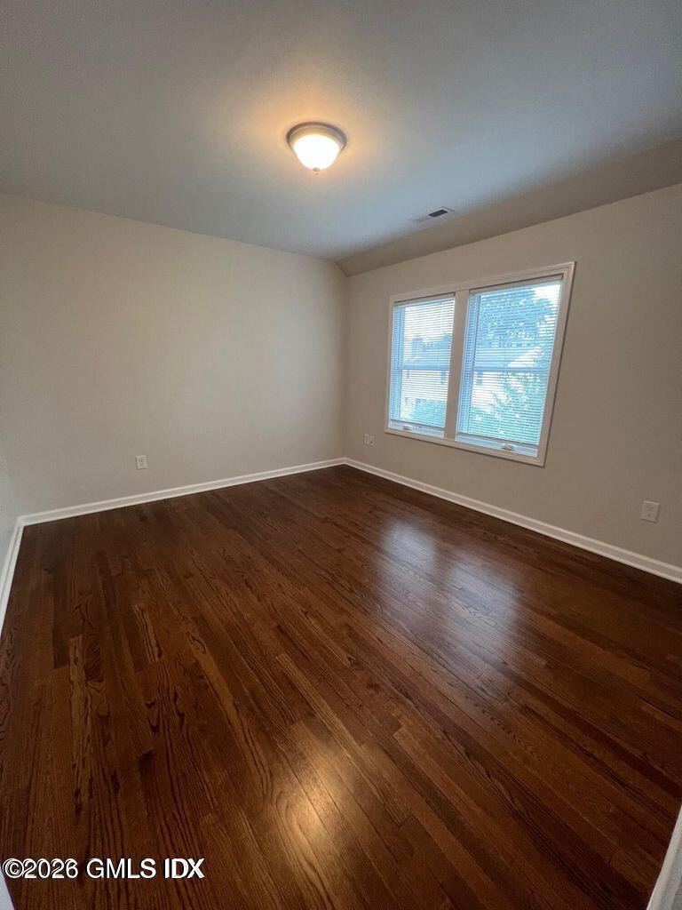 19 Bible Street, Unit 2 Cos Cob, CT 06807 - Photo 16 of 26 an empty room with wooden floor and windows