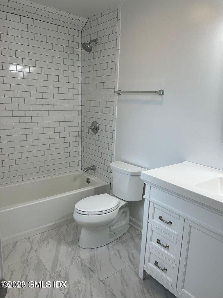 19 Bible Street, Unit 2 Cos Cob, CT 06807 - Photo 21 of 26 a white toilet sitting next to a bath tub