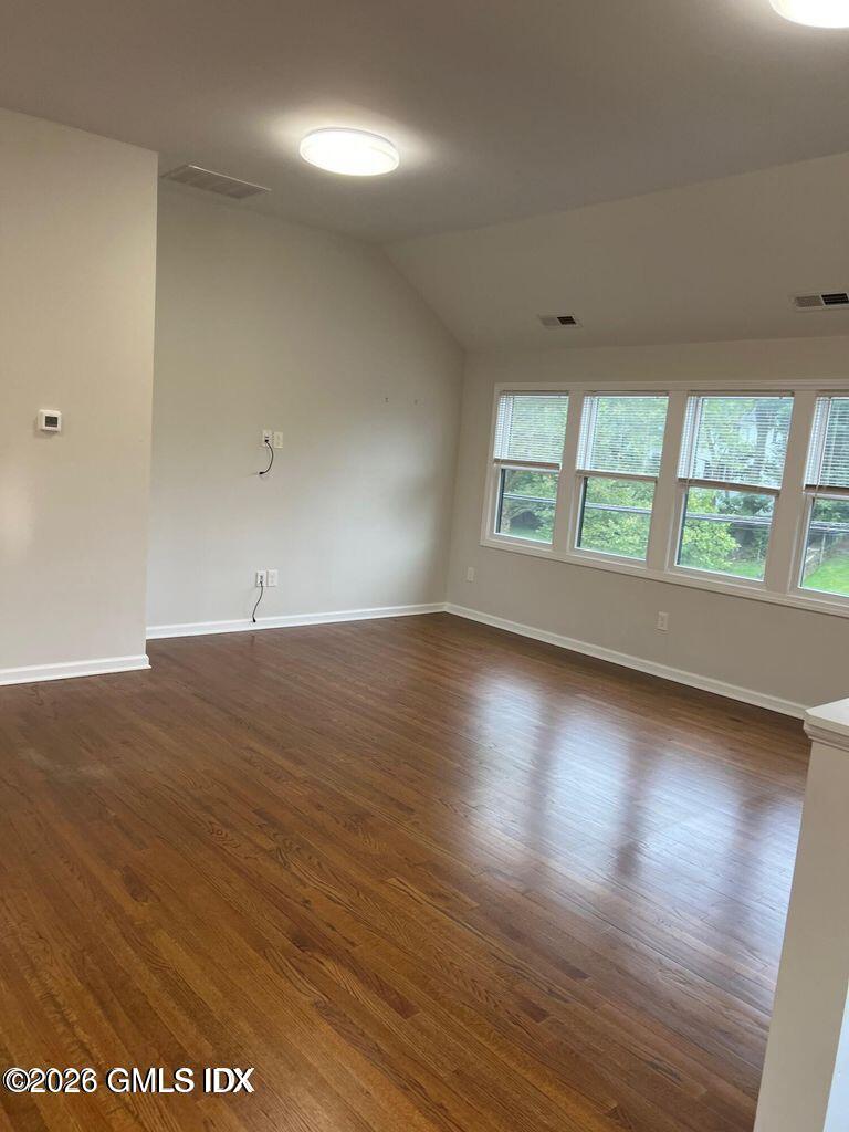 19 Bible Street, Unit 2 Cos Cob, CT 06807 - Photo 4 of 26 an empty room with wooden floor and windows