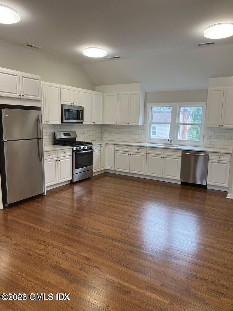 19 Bible Street, Unit 2 Cos Cob, CT 06807 - Photo 8 of 26 a kitchen with stainless steel appliances a refrigerator and a stove top oven