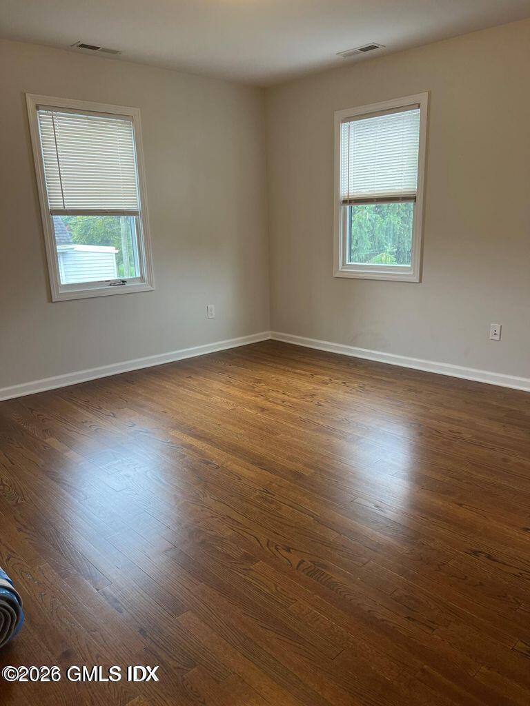 19 Bible Street, Unit 2 Cos Cob, CT 06807 - Photo 10 of 26 an empty room with wooden floor and windows