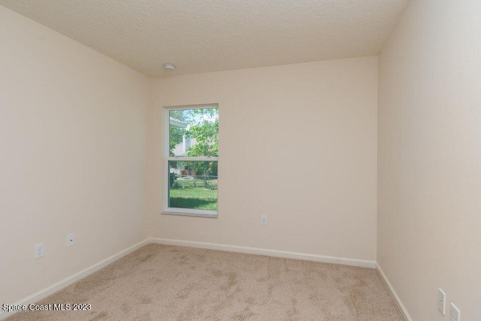 7210 Freeport Road Cocoa, FL 32927 - Photo 8 of 12 an empty room with a window