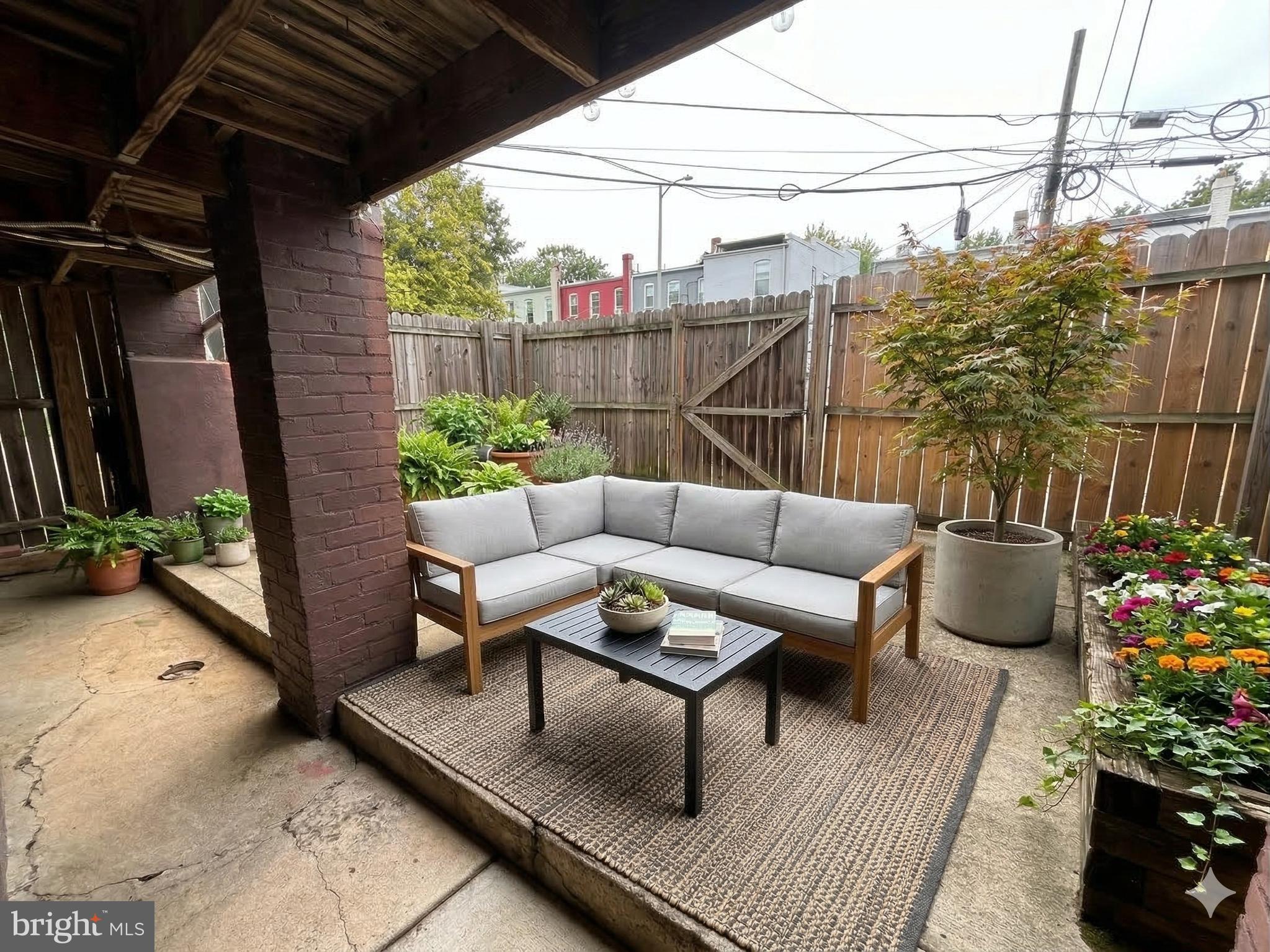a view of a patio with couches and potted plants