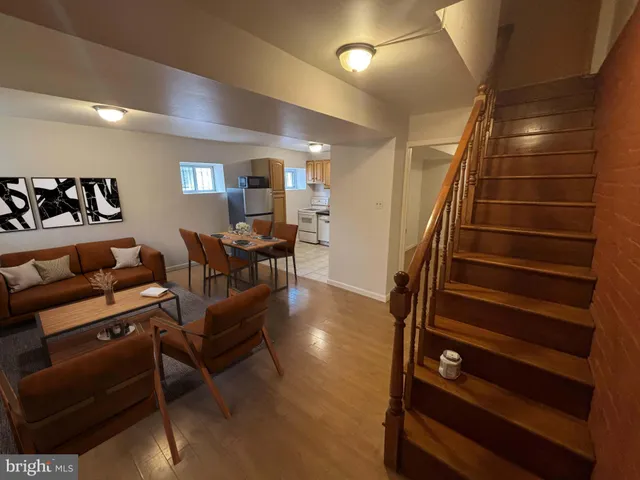 a view of a livingroom with furniture and staircase