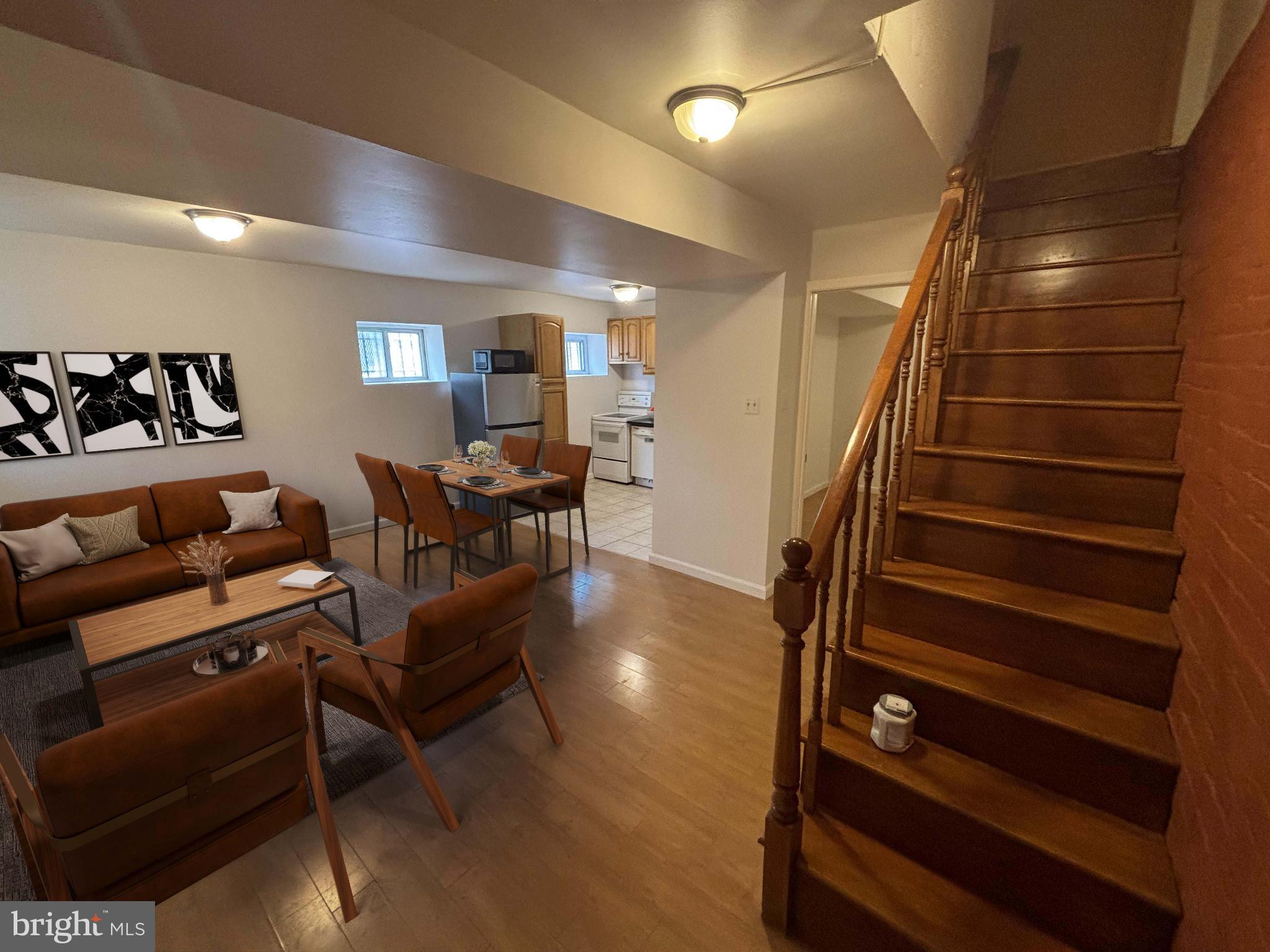 a view of a livingroom with furniture and staircase