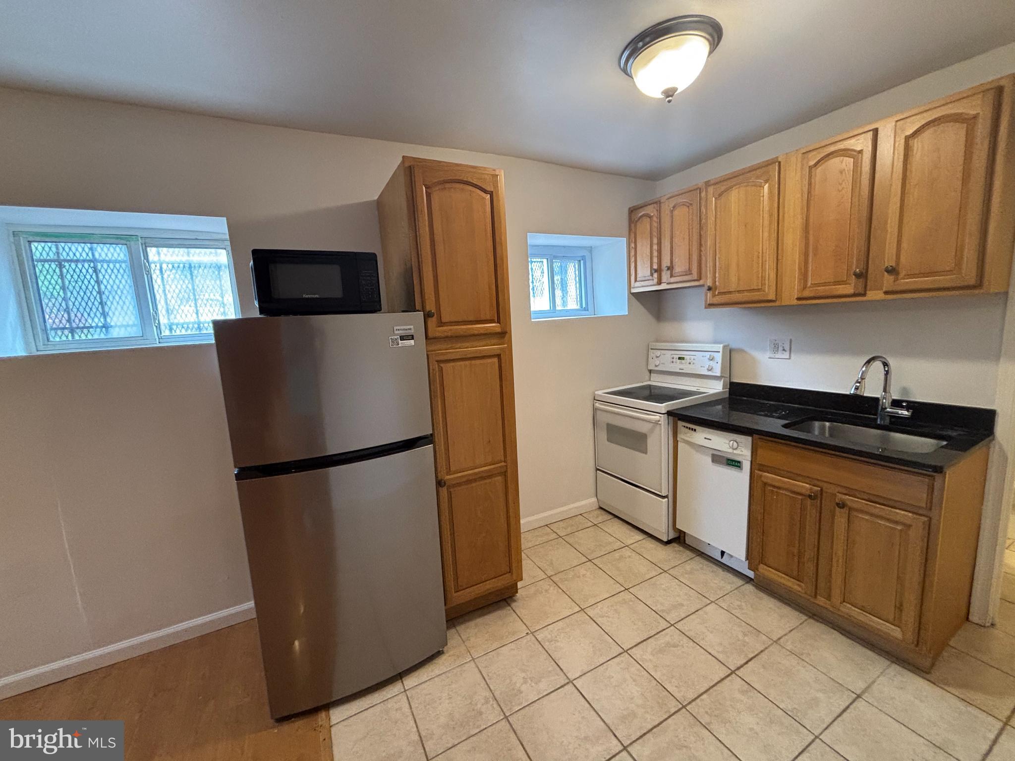 600 Keefer Place Northwest, Unit 1 Washington, DC 20010 - Photo 4 of 14 a kitchen with stainless steel appliances granite countertop a refrigerator sink and stove