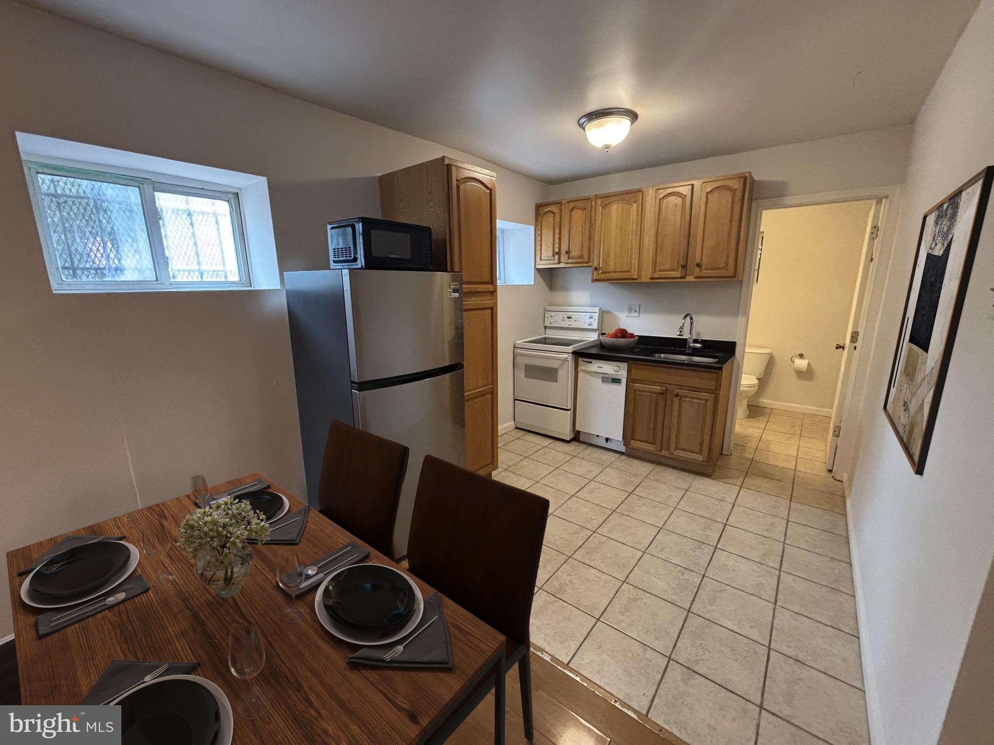 600 Keefer Place Northwest, Unit 1 Washington, DC 20010 - Photo 4 of 15 a kitchen with stainless steel appliances granite countertop a refrigerator stove top oven a sink and dishwasher