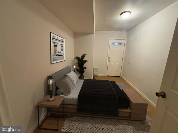 a bedroom with a bed and wooden floor