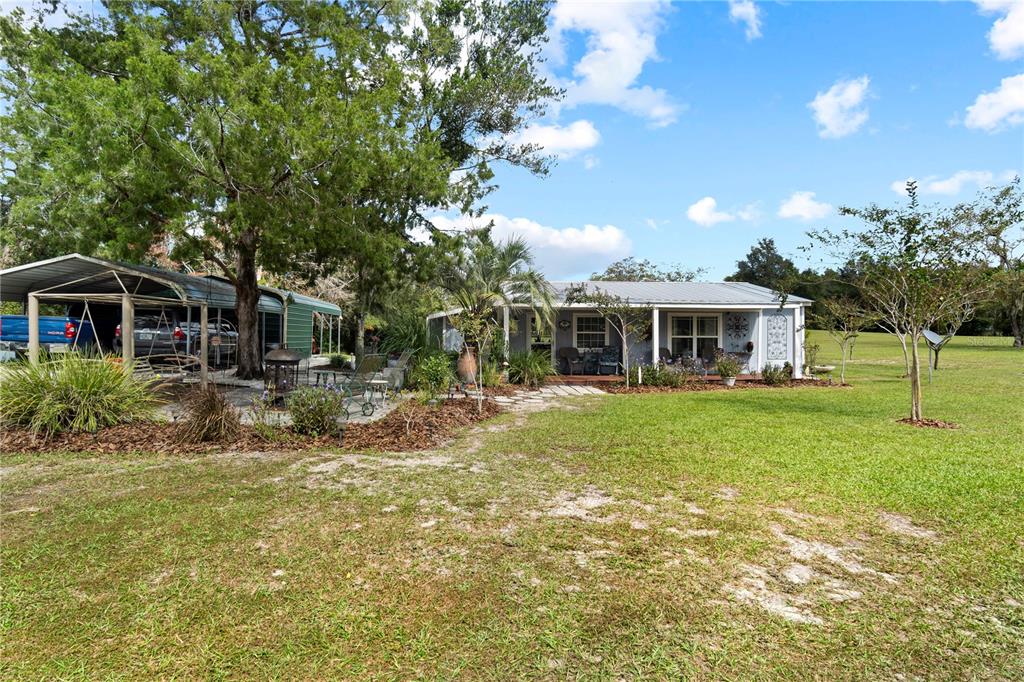 7650 Northeast 40th Street High Springs, FL 32643 - Photo 38 of 75 a front view of house with yard and green space