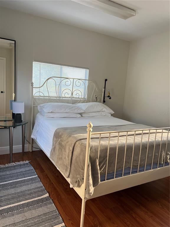 7650 Northeast 40th Street High Springs, FL 32643 - Photo 50 of 75 a bedroom with a bed and wooden floor