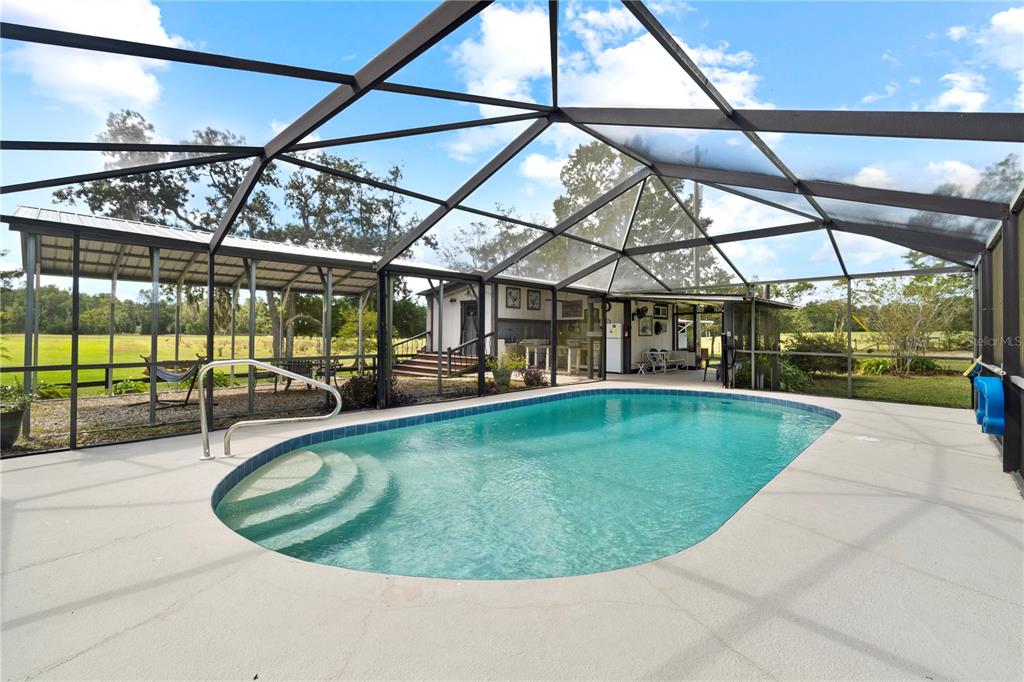 7650 Northeast 40th Street High Springs, FL 32643 - Photo 5 of 75 a view of a swimming pool with a patio and a yard