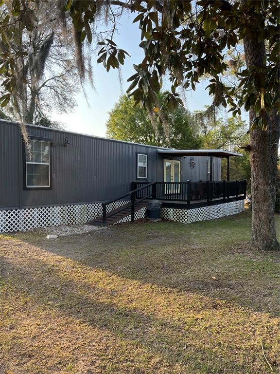 7650 Northeast 40th Street High Springs, FL 32643 - Photo 67 of 75 a view of a backyard with wooden fence and large tree