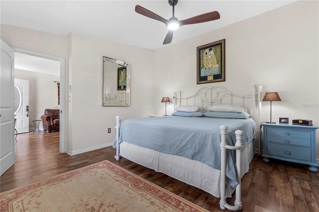 7650 Northeast 40th Street High Springs, FL 32643 - Photo 10 of 75 a bedroom with a bed and a chandelier