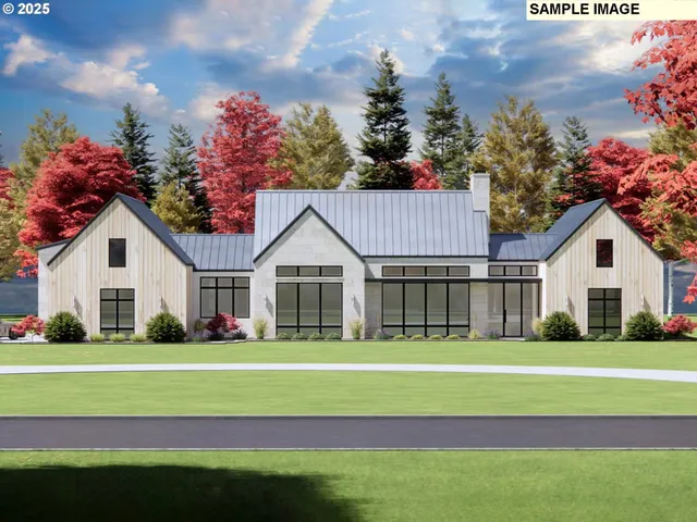 a front view of a house with a garden and trees