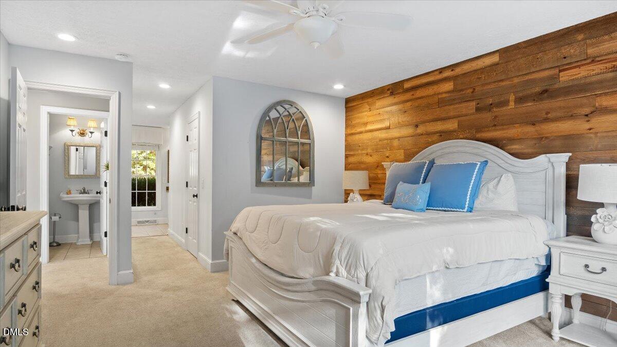 1121 Osmond Road Leasburg, NC 27291 - Photo 15 of 39 a bedroom with a bed and a painting on the wall