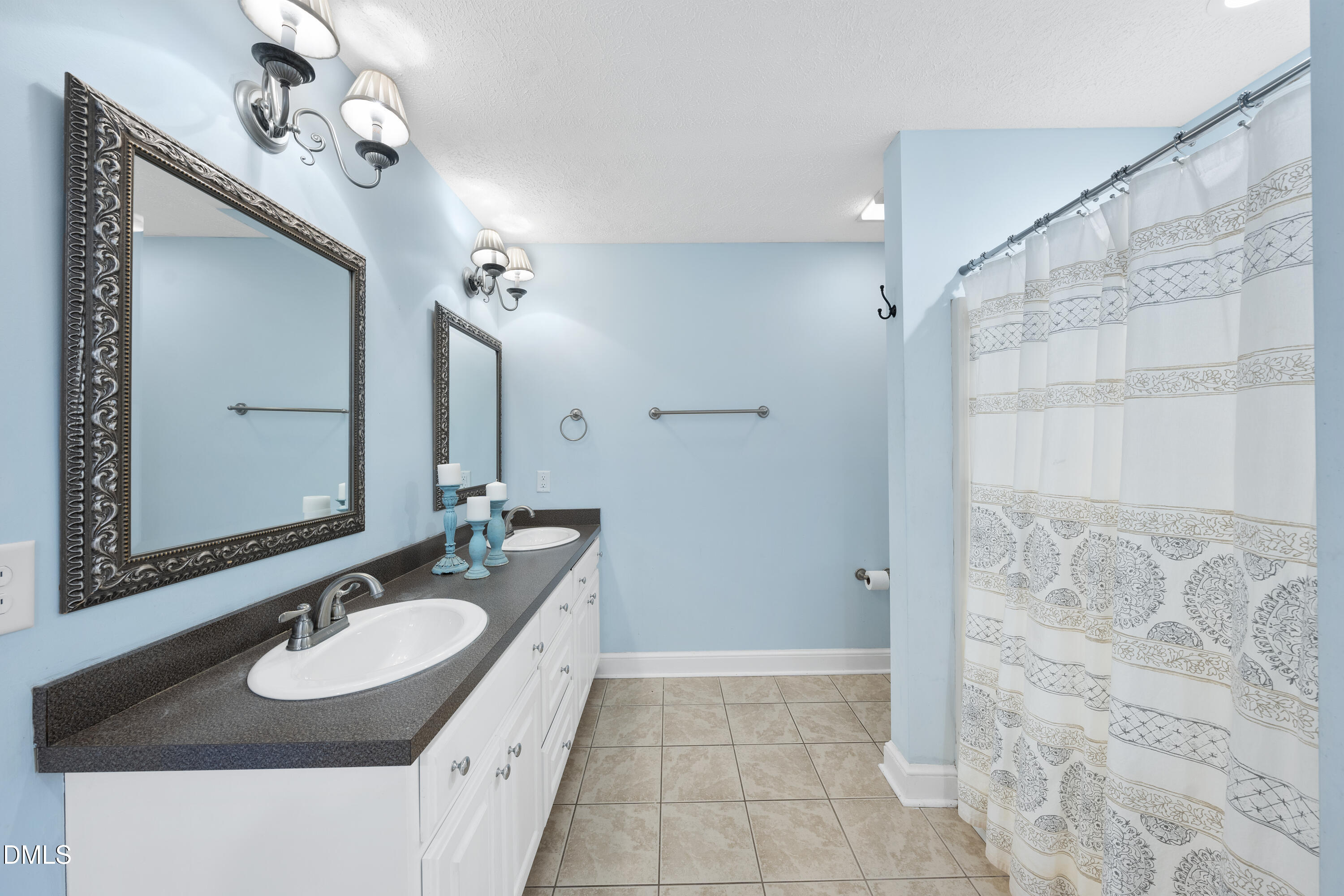 1121 Osmond Road Leasburg, NC 27291 - Photo 17 of 39 a bathroom with a granite countertop sink a mirror and a shower