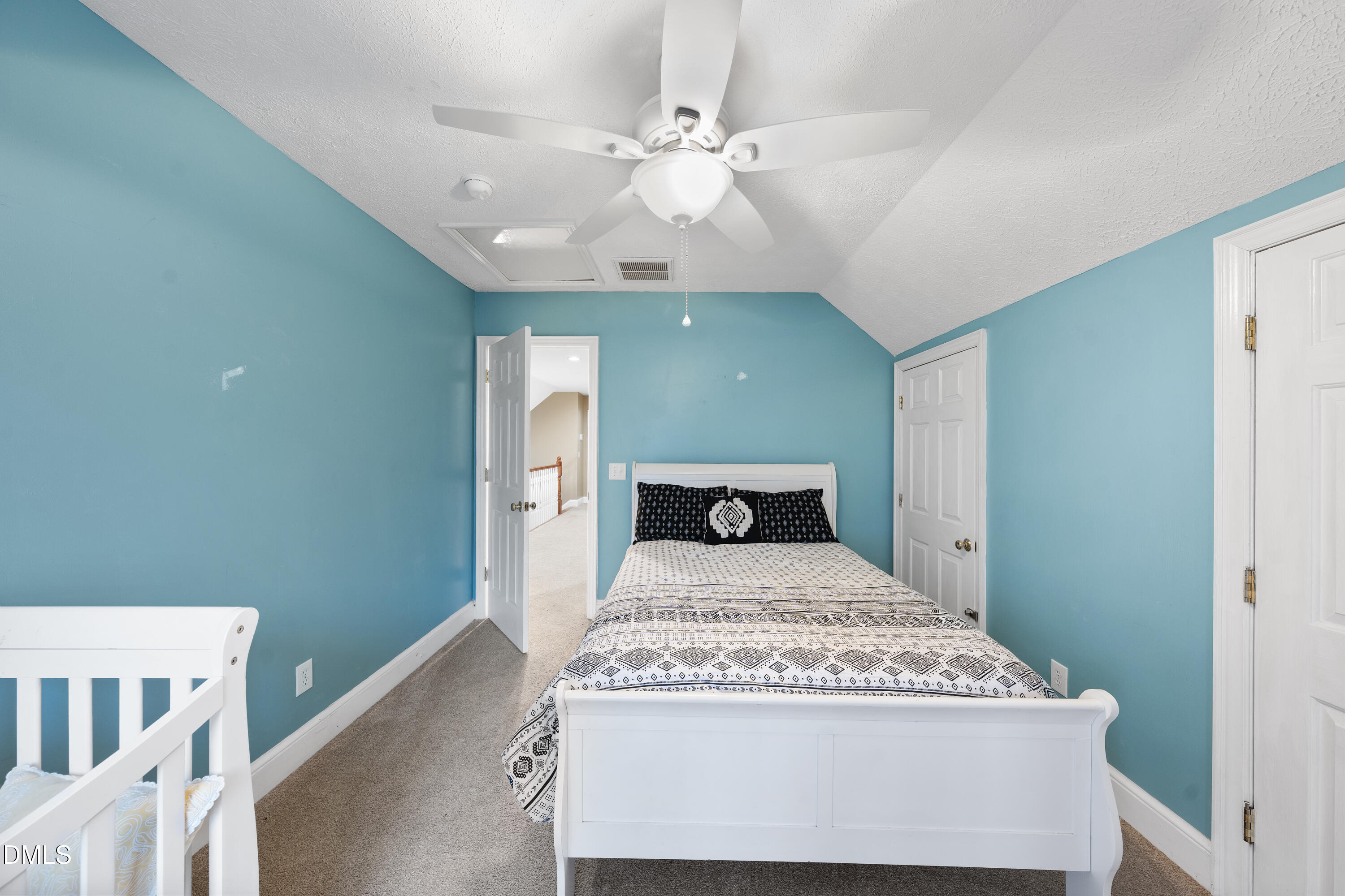 1121 Osmond Road Leasburg, NC 27291 - Photo 23 of 39 a bedroom with a bed and a chandelier