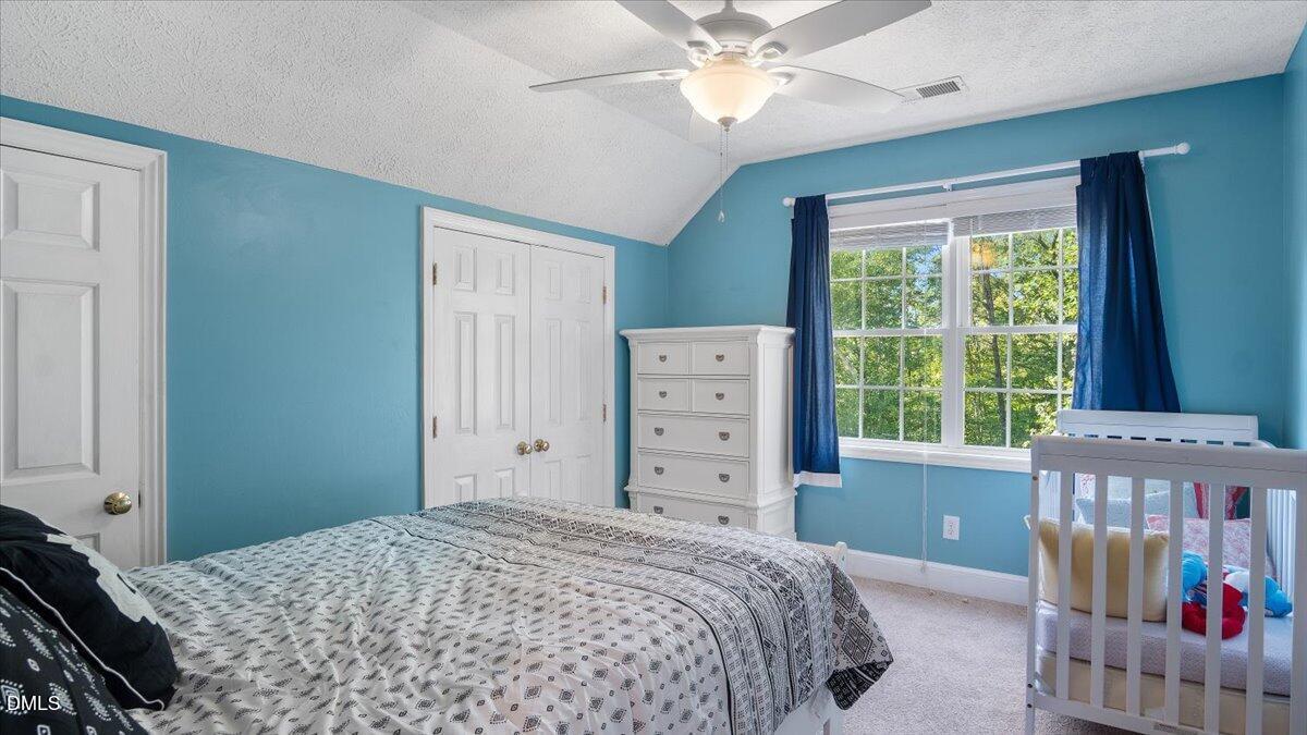 1121 Osmond Road Leasburg, NC 27291 - Photo 24 of 39 a bedroom with a bed and a window