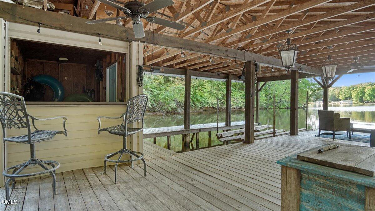 1121 Osmond Road Leasburg, NC 27291 - Photo 38 of 39 a view of a patio with table and chairs a barbeque with wooden floor and roof