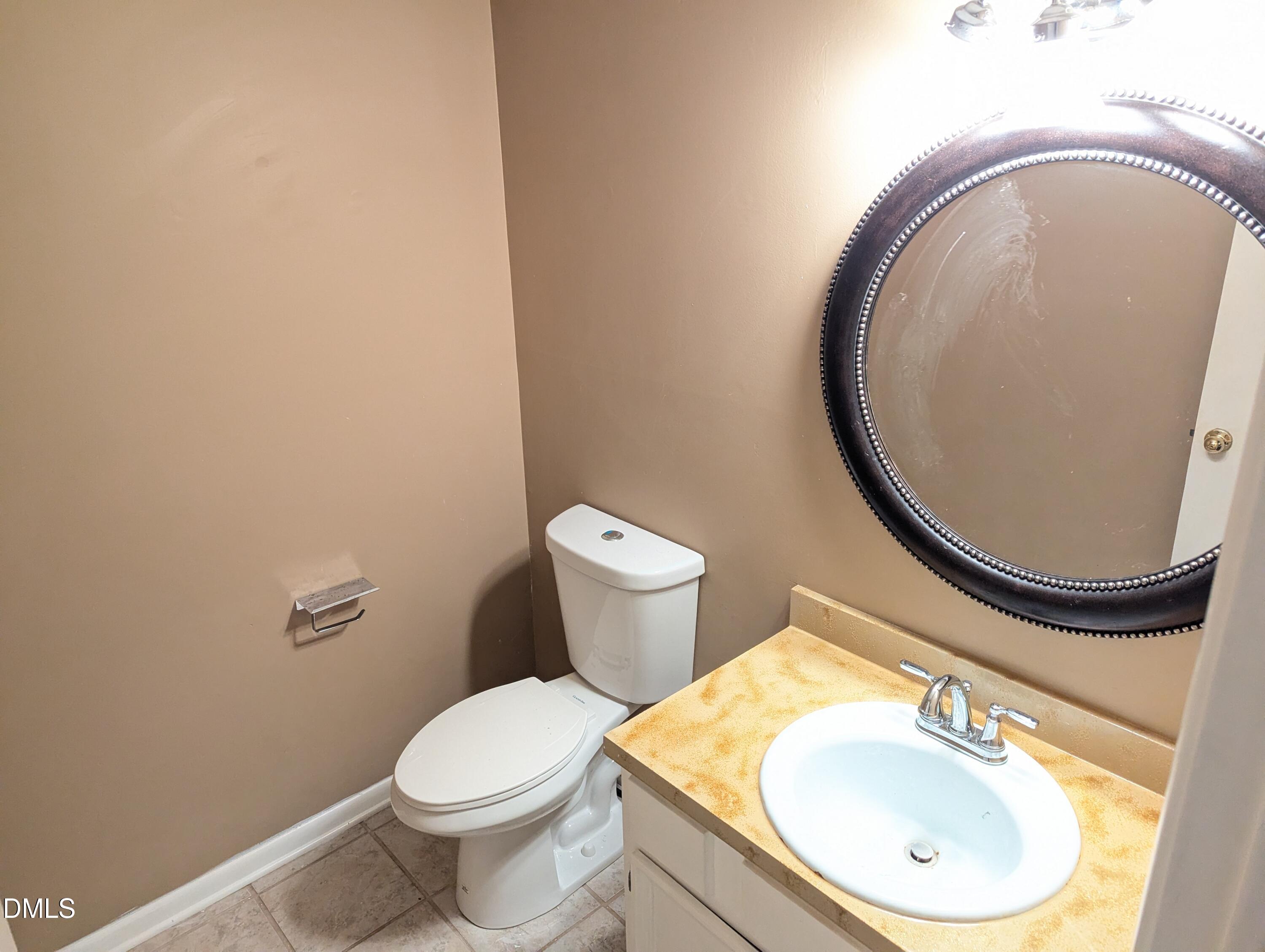 4100 Five Oaks Drive, Unit 49 Durham, NC 27707 - Photo 20 of 23 a bathroom with a toilet sink mirror and vanity