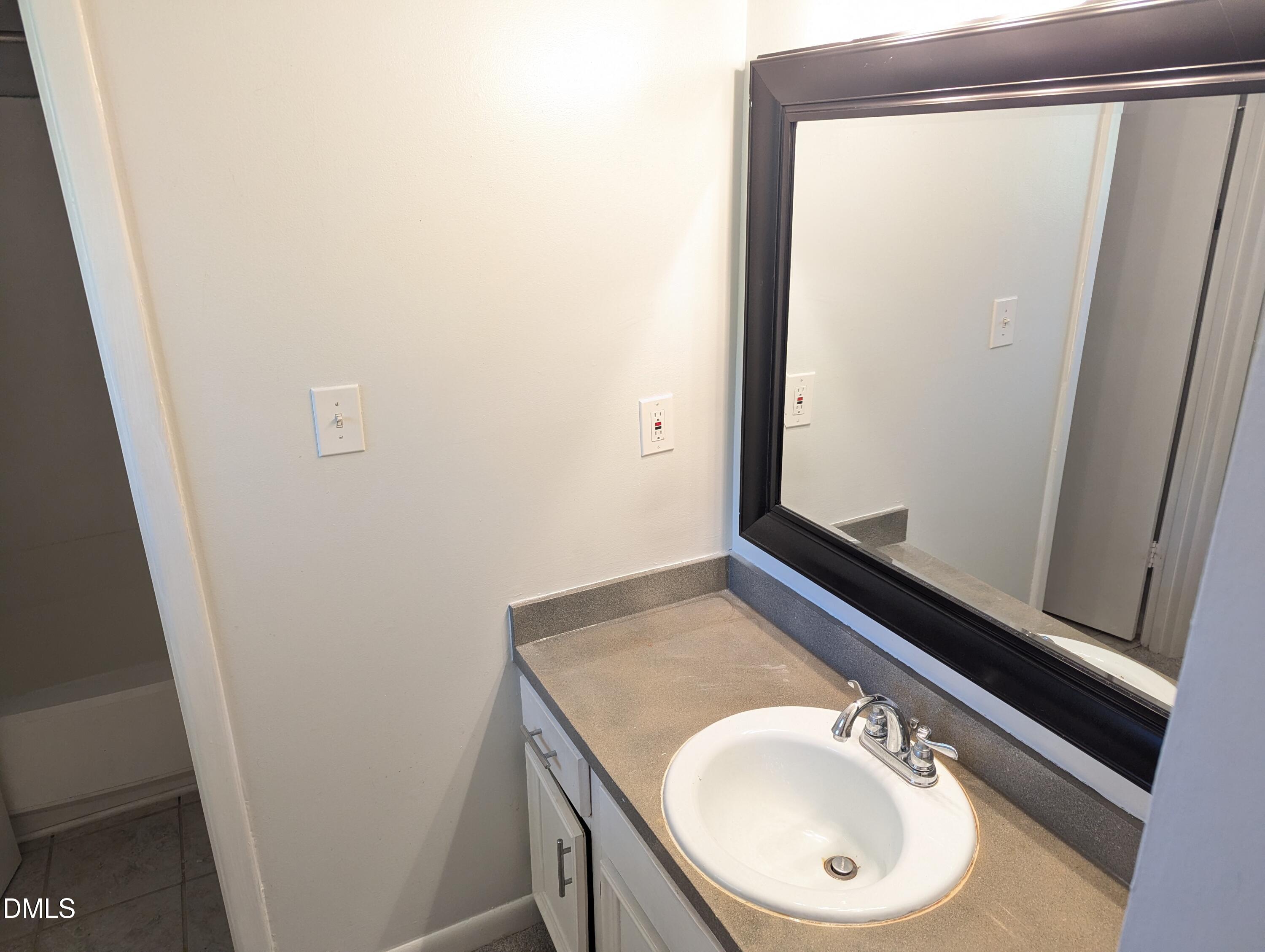 4100 Five Oaks Drive, Unit 49 Durham, NC 27707 - Photo 23 of 23 a bathroom with a sink and a mirror